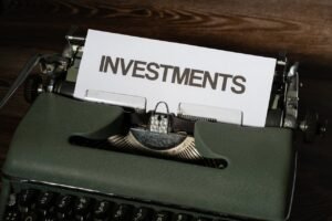 Close-up of a vintage typewriter with a paper labeled 'INVESTMENTS'.