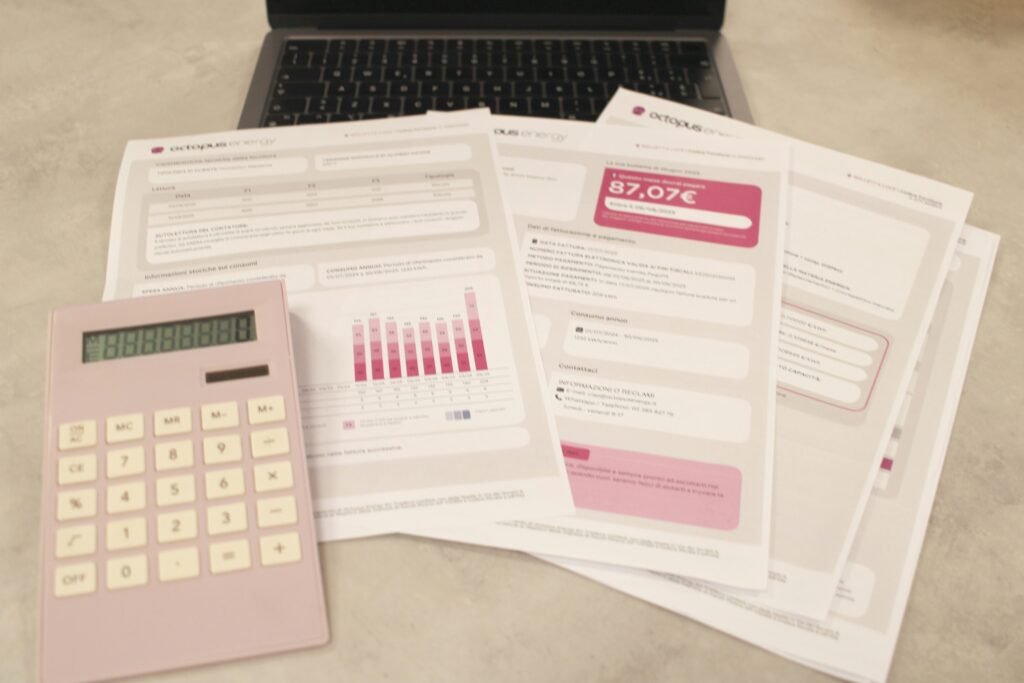 Close-up of hands doing budgeting calculations and savings planning with calculator and notes